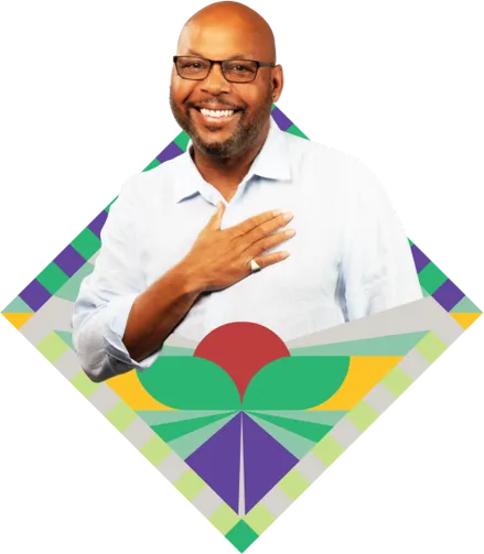 Headshot of a male caregiver of a sickle cell disease Warrior with one hand on his chest, surrounded by a colorful mosaic design